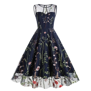 Close-up of intricate floral embroidery and sheer mesh neckline on this vintage navy dress