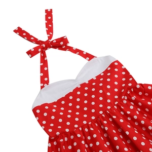 Detail of red polka dot dress featuring halter neck tie and white contrast trim detail