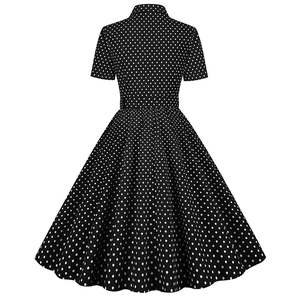 Back view of retro short sleeve polka dot dress with cinched waist and full A-line skirt