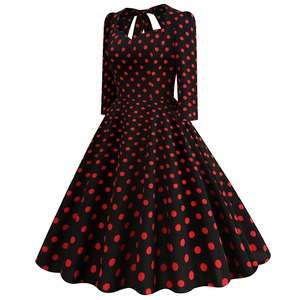 Detail of the sweetheart neckline and red polka dot pattern on the vintage dress