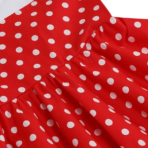 Detail of red and white polka dot pattern with pleated waistline on a girl's retro dress