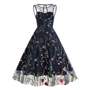 Detailed view of floral embroidery and mesh splicing on a navy blue A-line dress