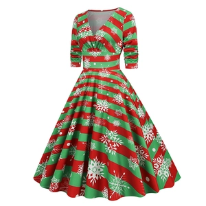 Detail of Christmas vintage A-line dress with red and green stripes and snowflake patterns
