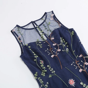 Detailed close-up of intricate floral embroidery on a navy blue sleeveless dress