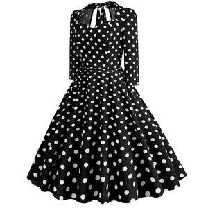 Detailed view of the sweetheart neckline and bow-tie collar on a polka dot retro dress