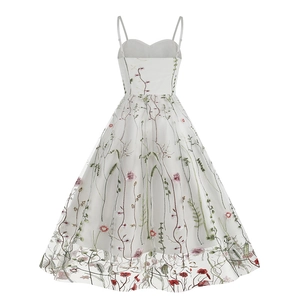 Close-up of colorful floral embroidery on white mesh fabric of the A-line midi dress