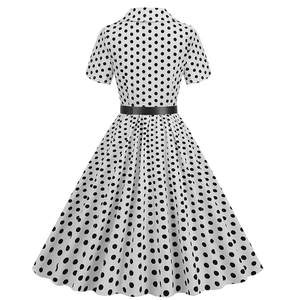 Rear view of vintage polka dot dress featuring A-line silhouette and black waist belt