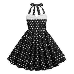 Detail of retro polka dot halter dress featuring white bow tie neck and vintage 1950s style
