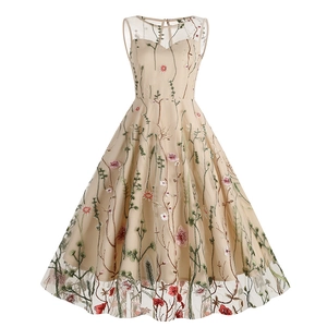 Detailed view of colorful floral embroidery and mesh fabric on a vintage A-line dress
