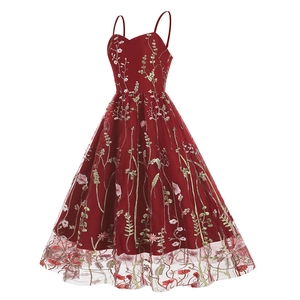 Detail of burgundy mesh dress showing intricate floral embroidery and 50s vintage style