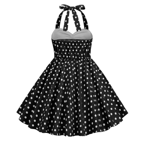 Detail of vintage girls halter neck dress with classic black and white polka dot pattern