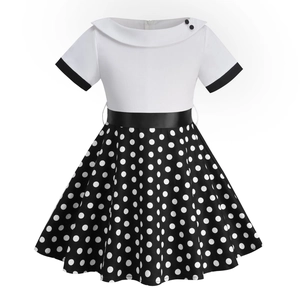 Vintage girls dress with white short sleeves, black waist belt and polka dot pattern skirt