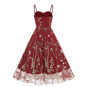 Detailed close-up of intricate floral embroidery on red mesh lace cocktail dress