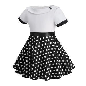 Close-up of girls' vintage polka dot dress featuring a white shawl collar and satin waist belt