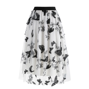 Women's white A-line mesh midi skirt featuring black butterfly embroidery and elastic waist