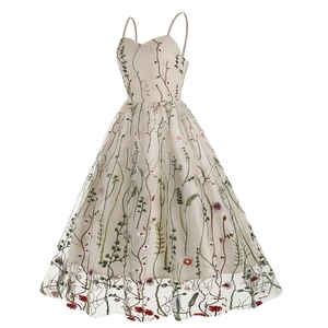 Detailed close-up of colorful floral embroidery on beige mesh fabric for a vintage dress