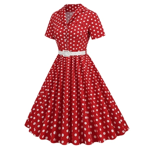 Detail of red polka dot dress featuring a V-neck collar, buttons, and white waist belt