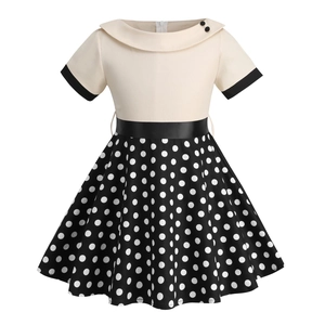 Retro girls' short sleeve dress with cream bodice, black sash, and white polka dot skirt