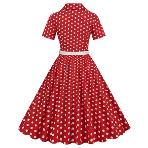 Detail view of red polka dot dress with shirt collar, short sleeves and white waist belt