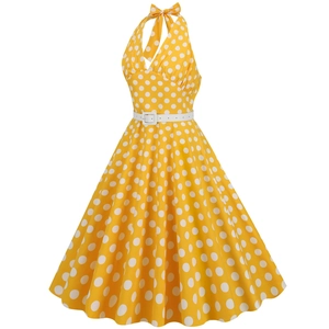 Detail of vintage yellow polka dot dress with white halter neckline and belt