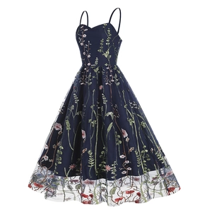 Close-up detail of exquisite floral embroidery and mesh layer on navy blue vintage dress