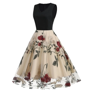 Detail shot of vintage floral embroidery and mesh layering on the retro midi dress skirt