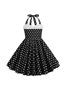 Vintage halter neck girls dress with white polka dots on black and a large A-line skirt