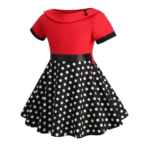 Detail of red bodice with wide collar and black polka dot skirt of a vintage girl dress