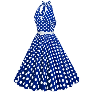 Detail view of a vintage polka dot halter dress with a slim white waist belt
