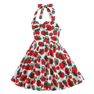 Detail of girls halter dress featuring vibrant strawberry print and bow decoration