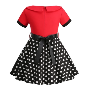 Detail view of the back of girls' vintage red dress with white polka dot skirt and bow belt