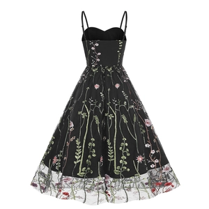 Detail of floral embroidery on vintage black mesh overlay of a retro 50s sundress