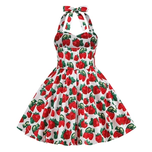 Detail of vintage girls' halter dress featuring vibrant strawberry print and bow neckline