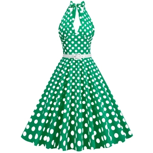 Vintage emerald green polka dot halter dress with a white waist belt and flared A-line skirt