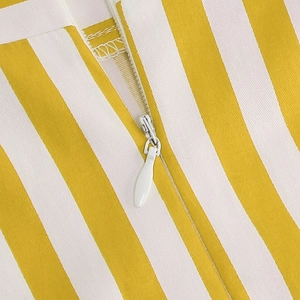 Close-up of invisible teardrop zipper on yellow and white vertical striped skirt fabric