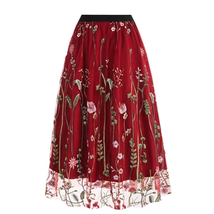 Detailed view of burgundy embroidery mesh skirt with floral patterns and elastic waistband