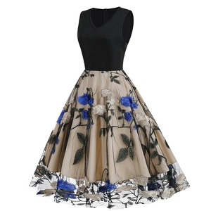 Detail of elegant V-neck dress featuring intricate 3D floral embroidery on mesh skirt