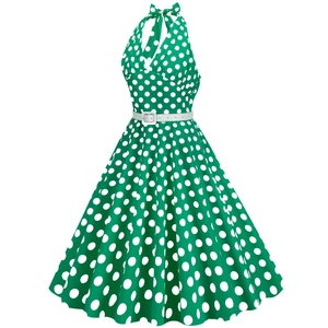 Detail of vintage polka dot halter dress with white waist belt and retro green fabric