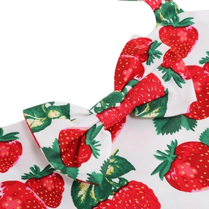 Detail of sweet strawberry floral print with decorative bow on a white cotton summer dress