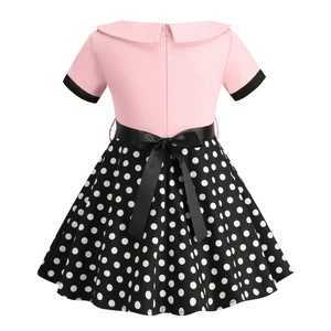 Detailed back view of a retro girls' dress featuring a black satin waist bow and polka dots