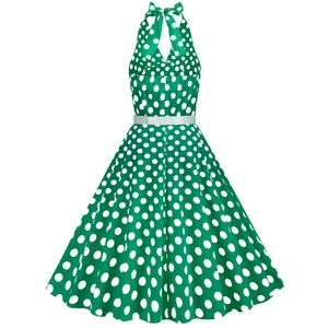 Detail showing the green polka dot dress with halter neck tie and white belt accessory