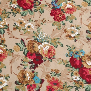 Close-up of vintage floral print fabric with red and yellow roses on beige background