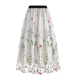 Women's vintage 50s white tulle midi skirt featuring colorful floral embroidery and black waistband
