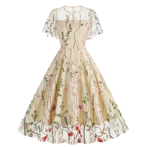 Detail of floral embroidery on apricot tulle dress with sheer short sleeves