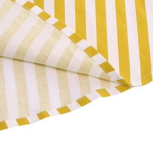 Detailed macro view of the yellow striped skirt hem with precision stitching