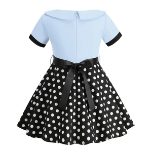 Detail view of the vintage polka dot girl dress featuring a black satin bow on the back