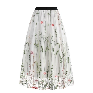 Detail of floral embroidery on a 50s vintage style mesh skirt with black elastic waistband