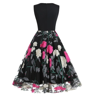 Detail of elegant black sleeveless vintage dress with floral embroidery and hidden zipper