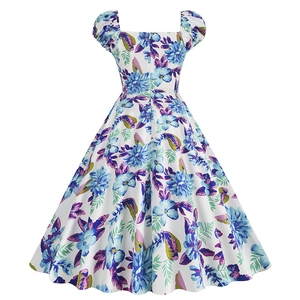 Detailed close-up of the vintage floral print and square neckline on the white dress
