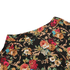 Detail of vintage floral print on black fabric featuring roses and paisley patterns
